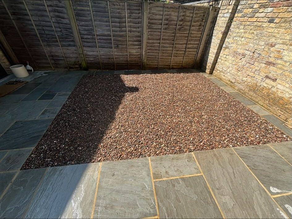 Gravel laid against sandstone paving